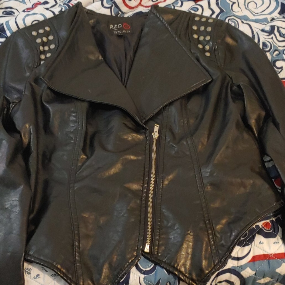 A fitted black rocker jacket with studs